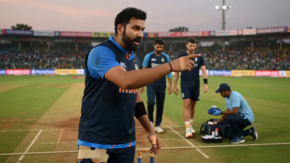 A fast bowler in full delivery stride during a floodlit T20 match, ball just released